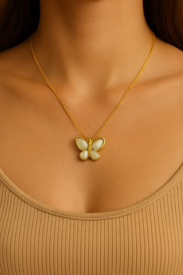 Elegant gold butterfly pendant with intricate wing details, designed as a luxury jewelry piece for a sophisticated and modern style